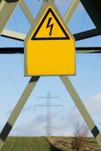 Electricity pylon with sign — Stock Photo, Image