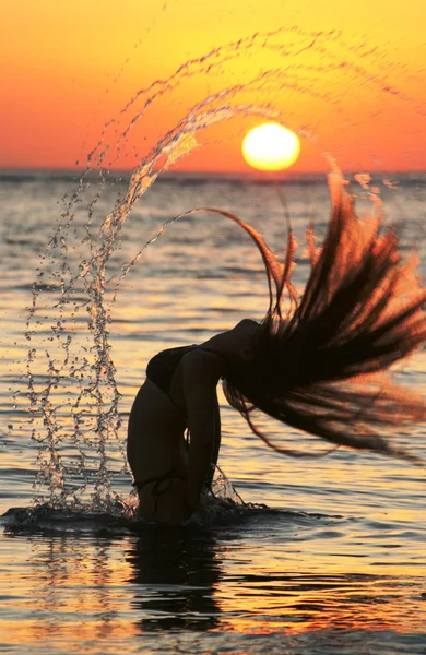 stock image The girl the mermaid comes up from water on a decline