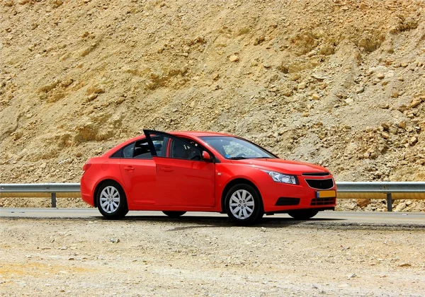 stock image Red car on a mountain road