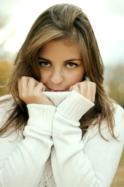 Portrait of the beautiful girl in a white sweater — Stock Photo, Image