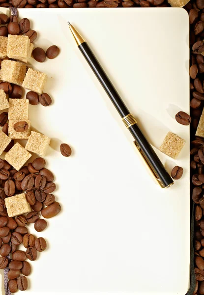 Stock image Coffee beans, paper, pen