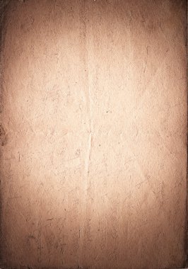 Vintage paper with vignette and light spot in the center. Brown clipart