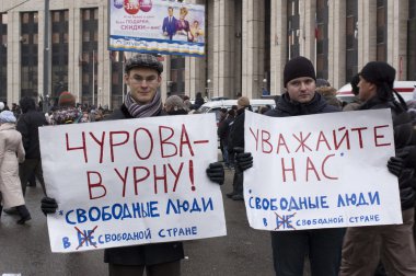 MOSCOW - DECEMBER 24: Two men with posters calling for resignati clipart