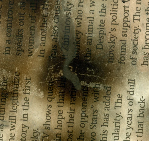 Burnt & damaged newspaper txt — стоковое фото