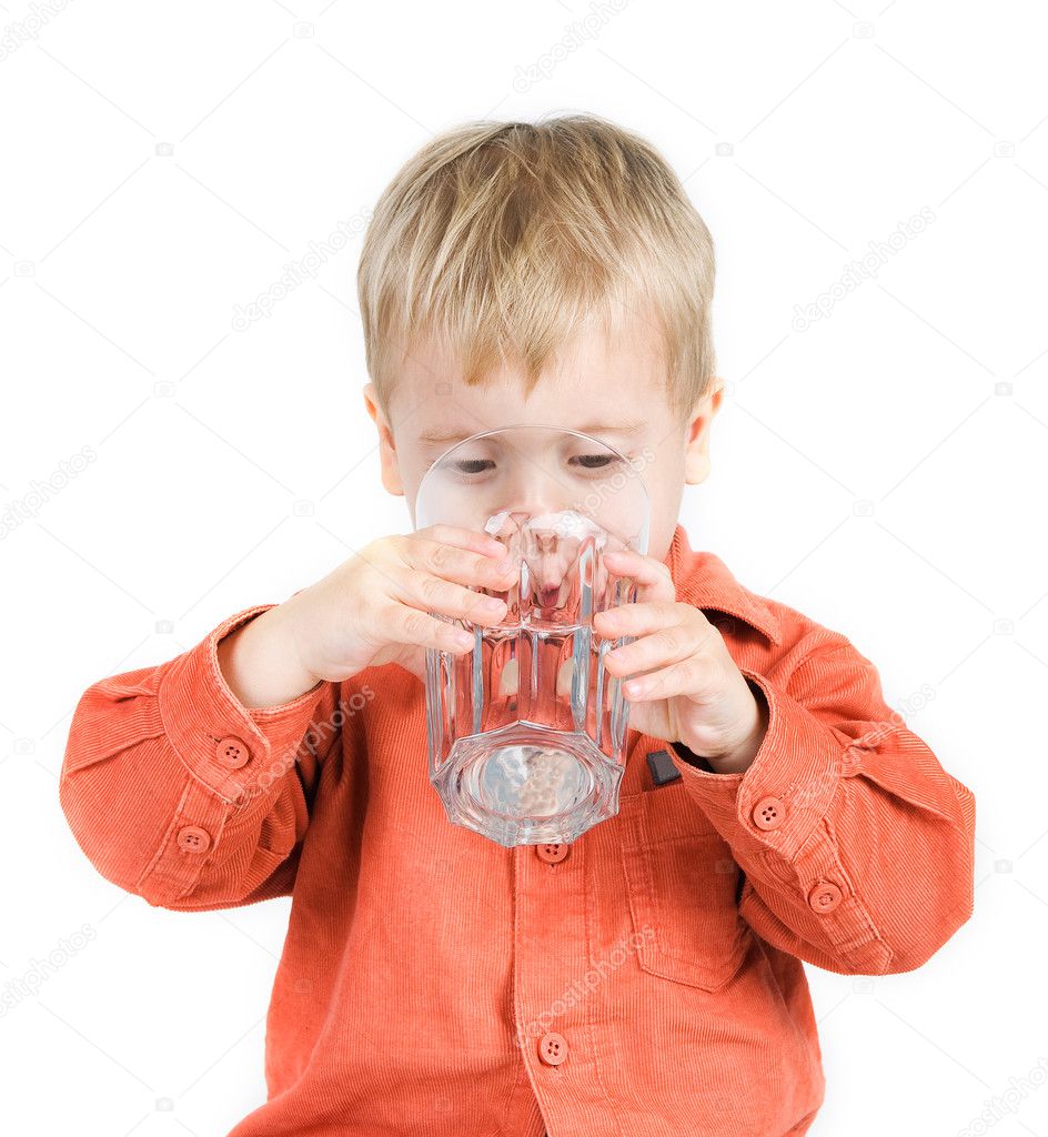 The boy drinks water from a glass