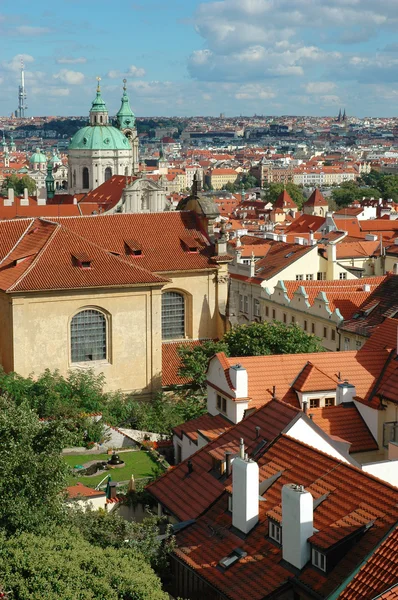 St. Nicholas Church and the red roofs in Prague — Stock Photo, Image