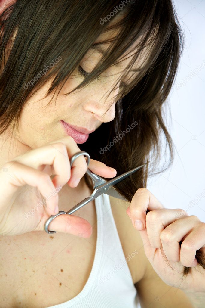 Female model cuts her own hair