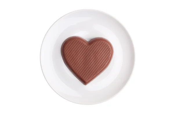 Flat chocolate heart on a saucer — Stock Photo, Image