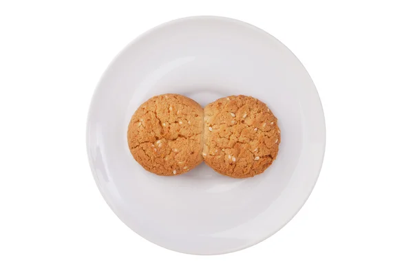 Deux biscuits en verre fondu sur une soucoupe blanche — Photo