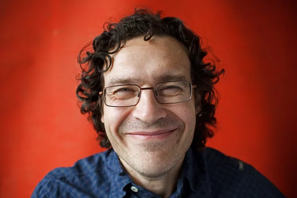 Shaggy and unshaven smiling man with glasses — Stock Photo, Image