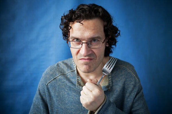 Man threatening species with fork in hand