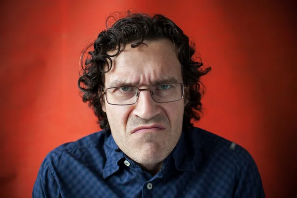 Man wearing glasses with a grimace of displeasure — Stock Photo, Image