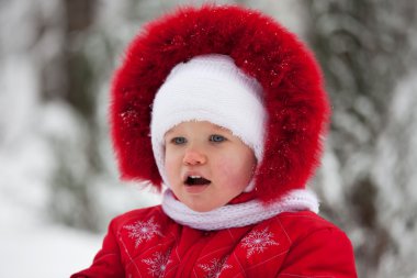 Little girl in a red winter suit clipart