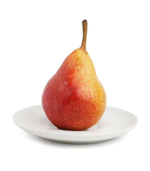 Ripe pear and saucer — Stockfoto