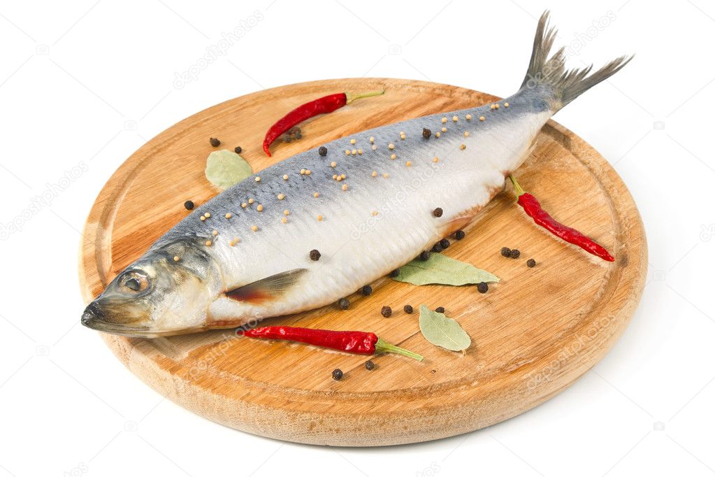 Herring on wooden hardboard with spice