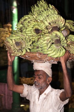 Man Carrying Bananas clipart