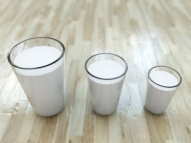 Milk glasses on wooden floor clipart