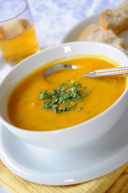 A bowl of carrot and lentil soup clipart