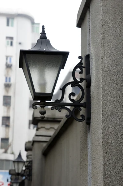 Lamp on fence wall — Stock Photo, Image