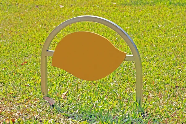 Blank stainless sign post on grass — Stok fotoğraf