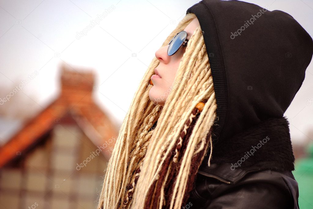 Young beautiful blonde with dreadlocks in sun glasses and hood