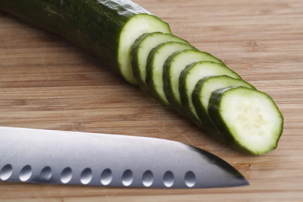 stock image Cucuber with knife