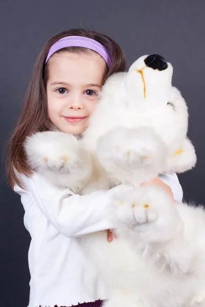 stock image Little girl's hugging a bear