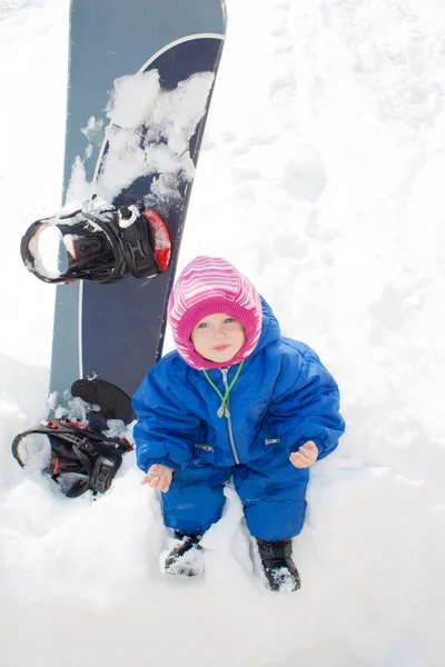 Baby and snow board — Stock Photo, Image