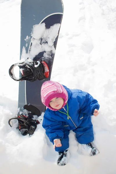 Baby and snow board — Stock Photo, Image