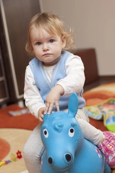 Baby riding a toy horse — Stock Photo, Image