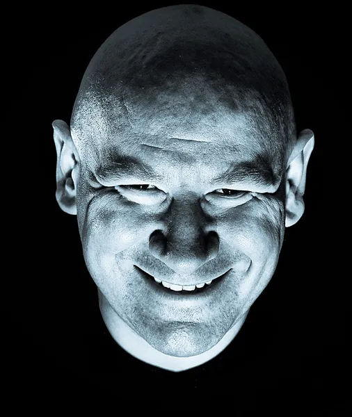 Menacing scary smiling bald man