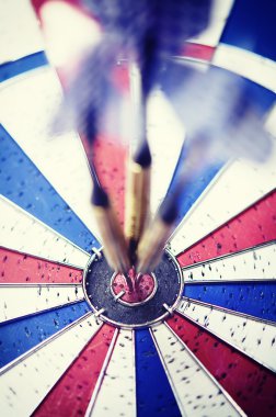 Dart in motion hitting bullseye clipart