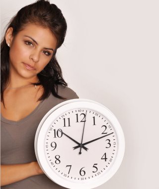 Young woman holding a clock. clipart