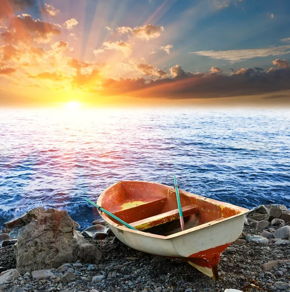 Туристичний човен на узбережжі на заході сонця — стокове фото