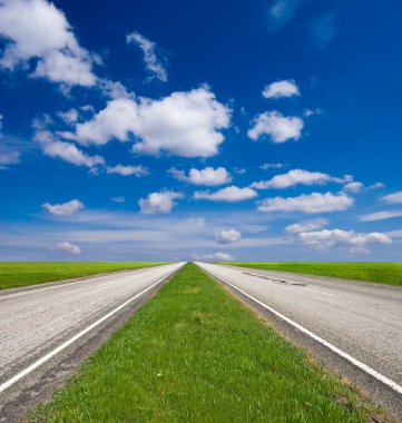 Two way asphalt road and green fields clipart
