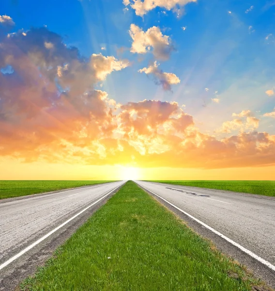 stock image Asphalt road leaving far to a sunset