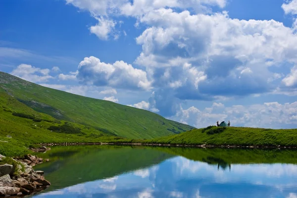 Yeşil tepelerin arasında göl — Stok fotoğraf