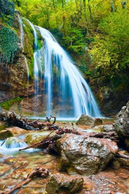 Majestic blue jurjur waterfajj in a krimea mountains clipart