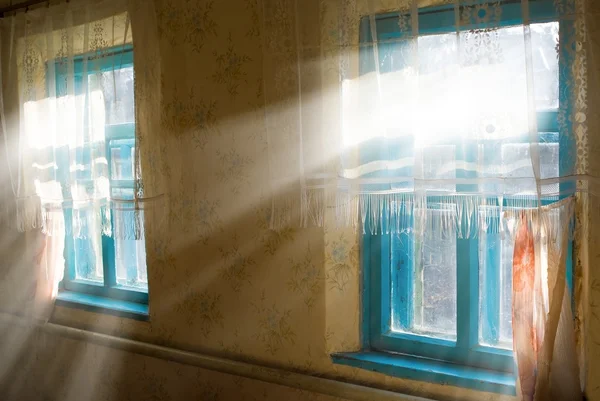 Rays of sun pushing through a room window — Stock Photo, Image