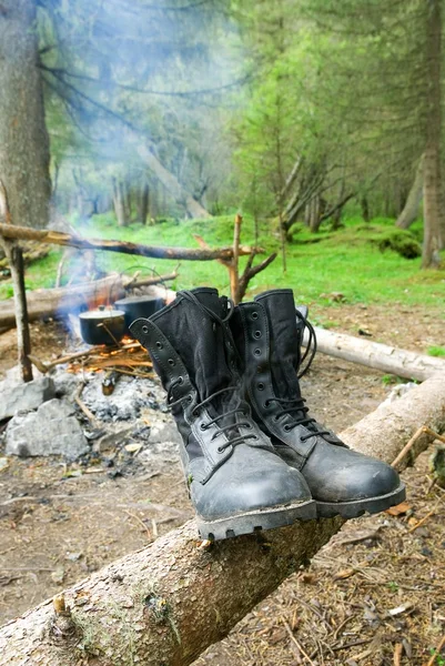 stock image Touristic boots near a camp