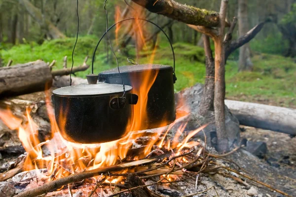 Touristic campfire and two cauldrons