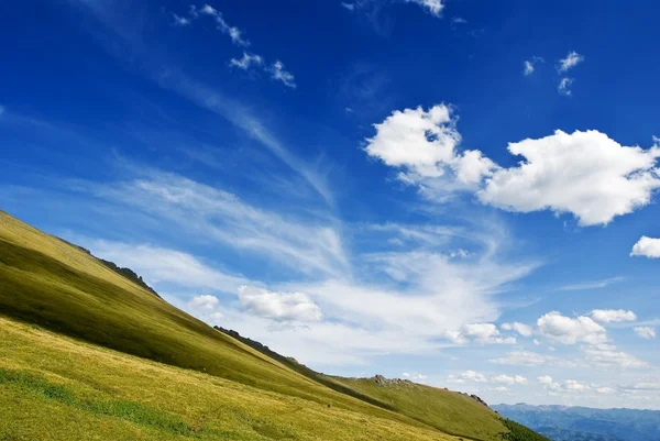 Gröna kullar på en himmel bakgrund — Stockfoto