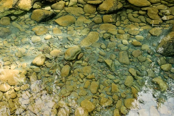 Small stones in a water — Stock Photo, Image