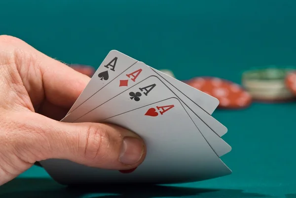 Playing cards in a hand on a green felt — Stock Photo, Image
