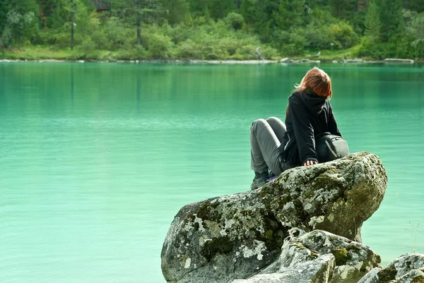 stock image Girl sitting on a sea coast