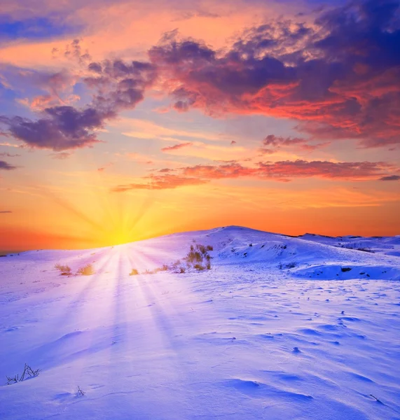 Pôr do sol em uma planície com neve de inverno — Fotografia de Stock