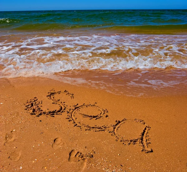 Signo del mar sobre una arena — Stok fotoğraf