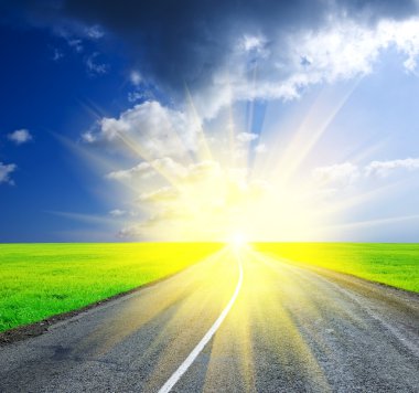 Asphalt road leaving far to a sunrise clipart