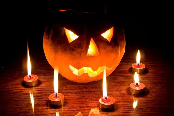 Jack lantern in a dark among a candles — Stock Photo, Image