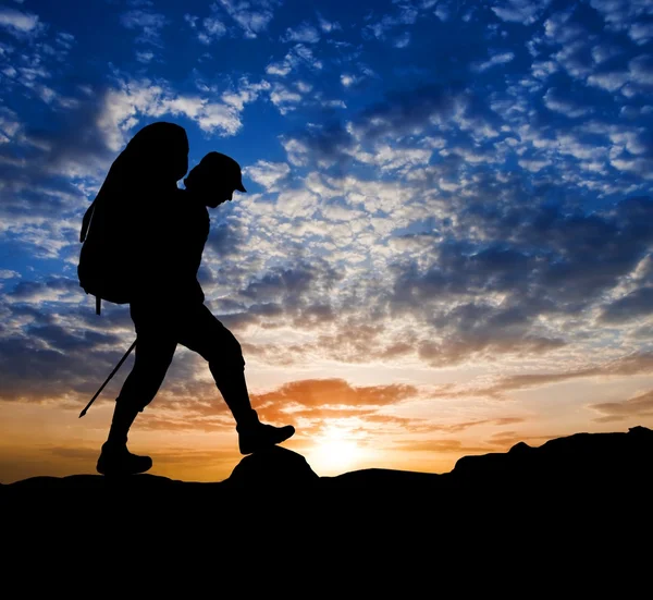 stock image Hiker silhouette on a sunset background